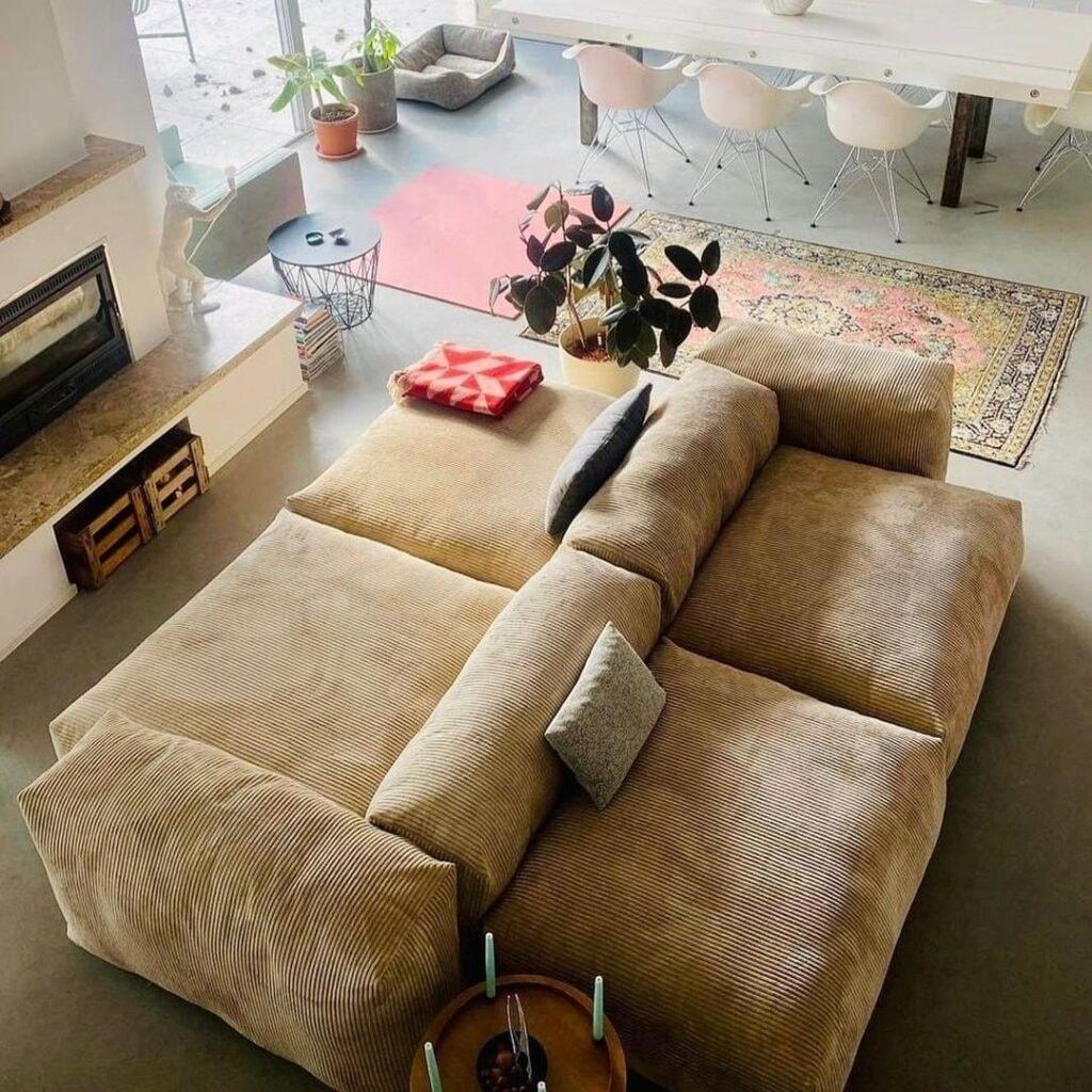 modular sofa replica by vetsak in front of fireplace